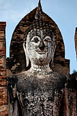 Thailand, Old Sukhothai - Wat Mahathat, detail of the statue of standing Buddha enshrined in a mandapa on the side of the main chedi.  